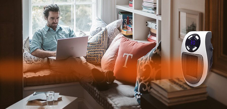 man getting warm while working on the computer thanks to Cozy Heat Tech